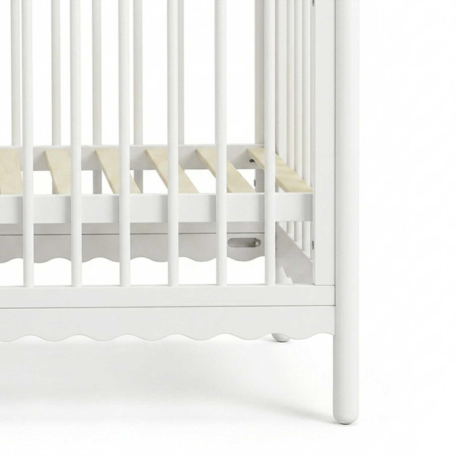 Close-up of crib slats and legs on a white background