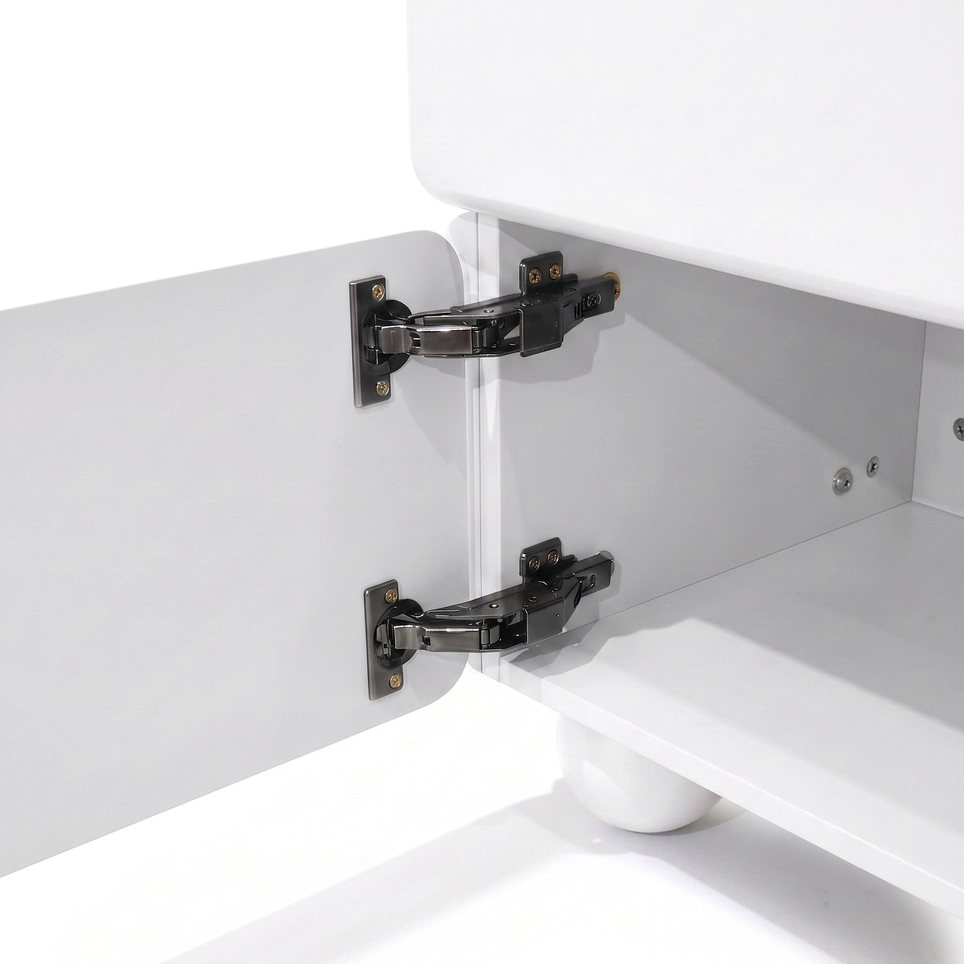 Close-up of cabinet interior with concealed hinges on a white furniture piece