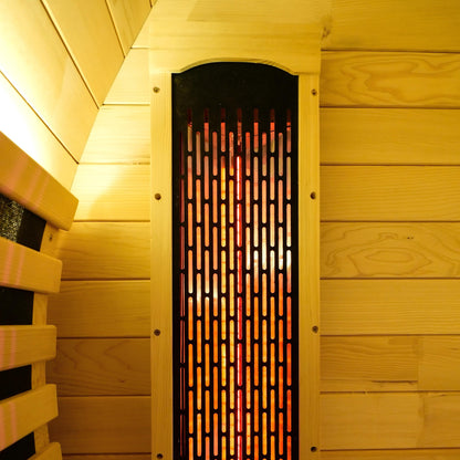 Close-up of a black infrared heater panel in a wooden sauna wall