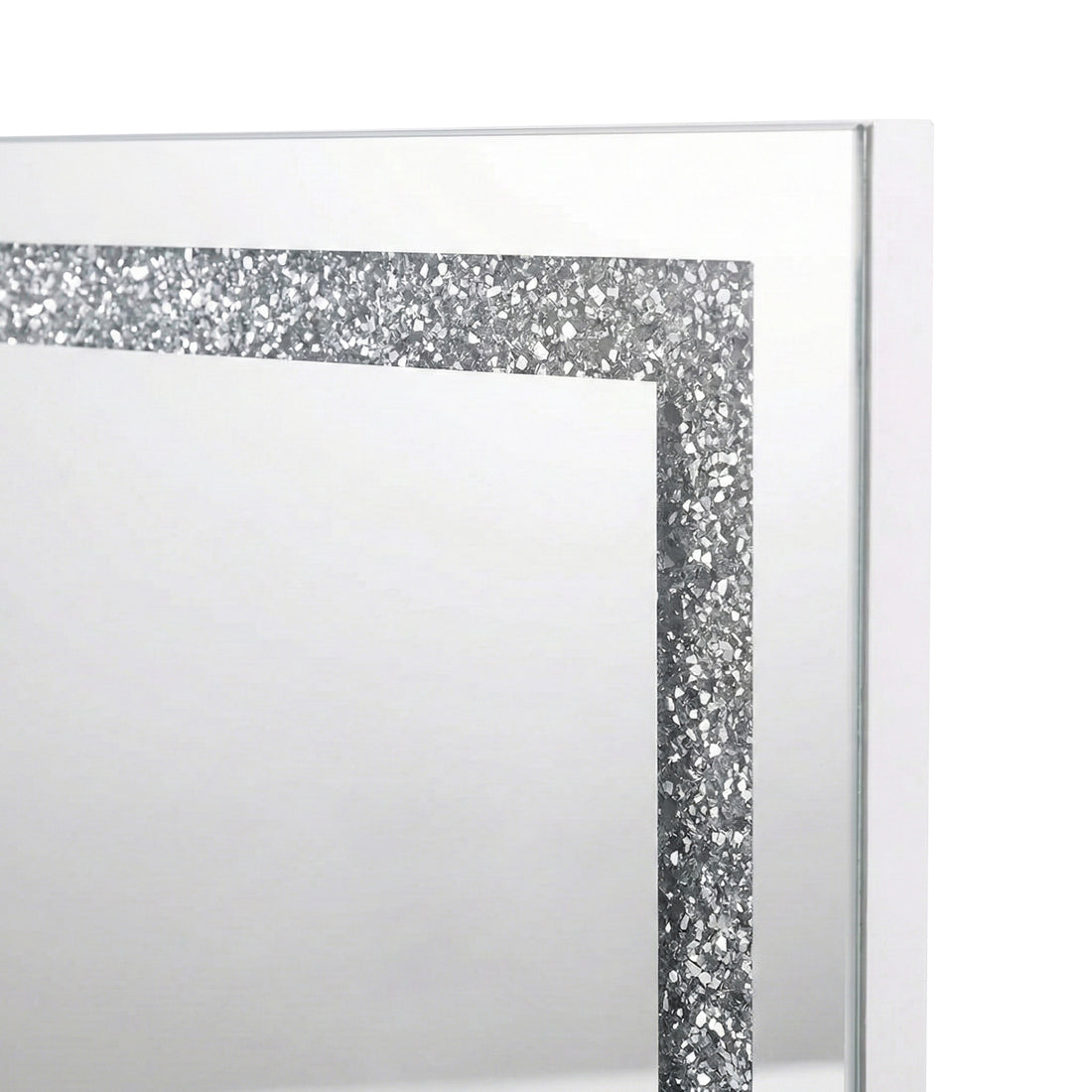 Close-up of upper left corner of mirror showing glitter border on white background