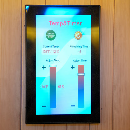 Digital sauna control panel mounted on a wooden wall