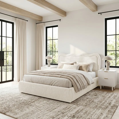 Cream upholstered bed in styled bedroom setting