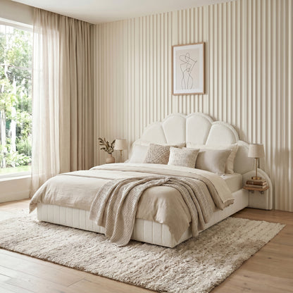 Cozy bedroom with upholstered scallop headboard bed styled with pillows and neutral decor