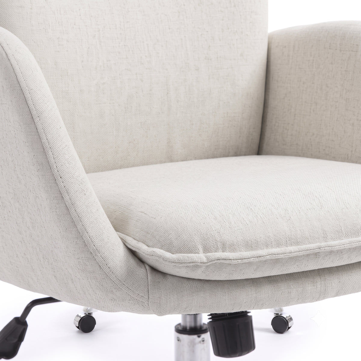 Close view of a beige upholstered office chair seat and armrests on a white background