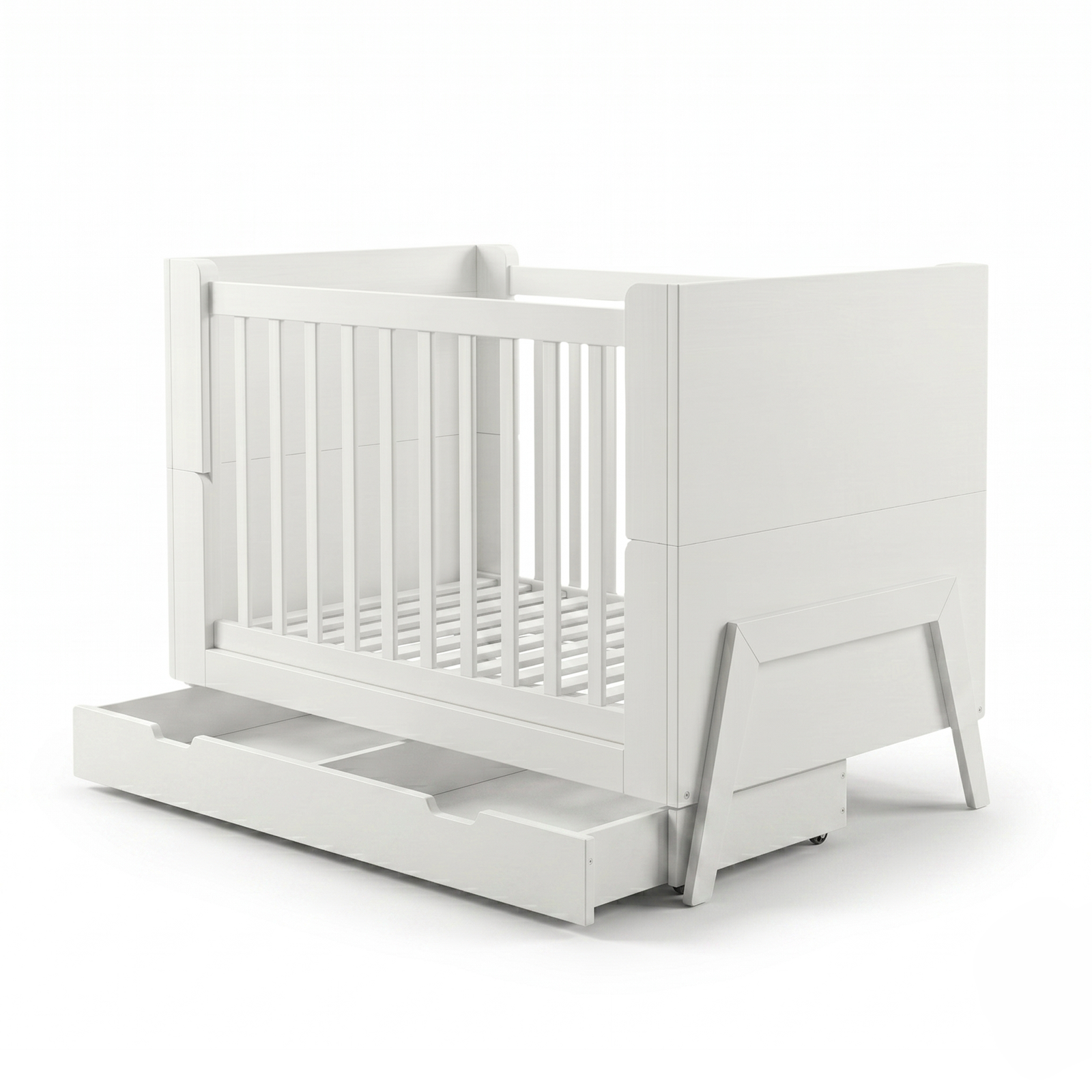 White crib on white background angled showing slats and pull-out drawer
