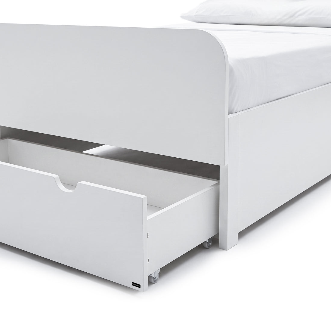 Close-up of the lower section of a white bed frame with an open storage drawer.