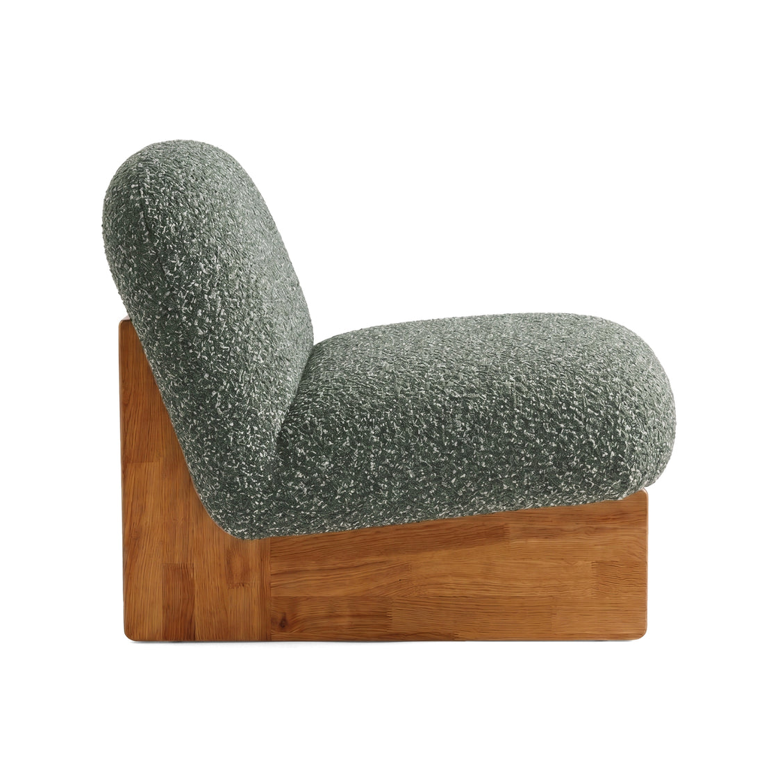 Side profile of green accent chair on white background