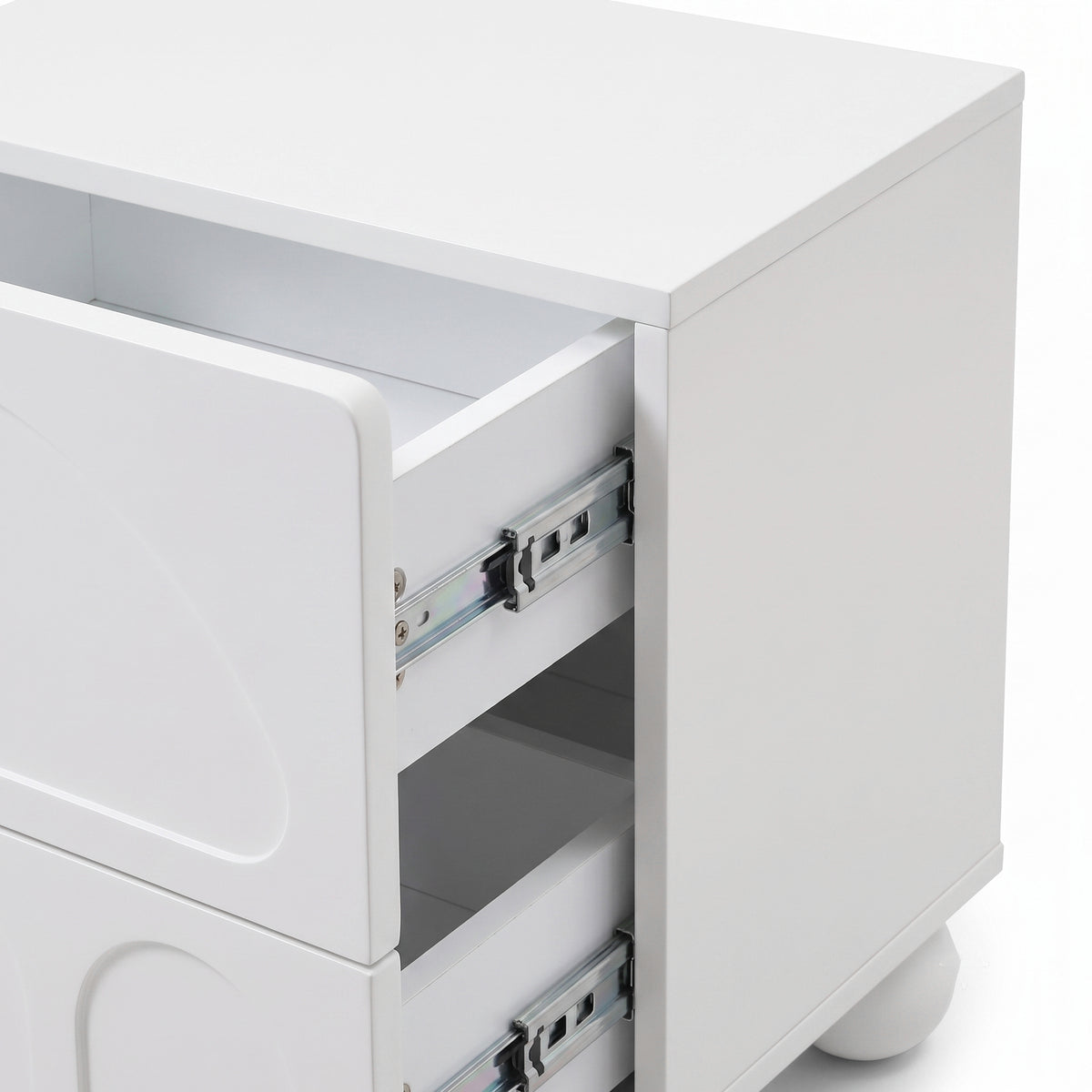 Partial view of a white modern nightstand showing the front and side with one drawer open.