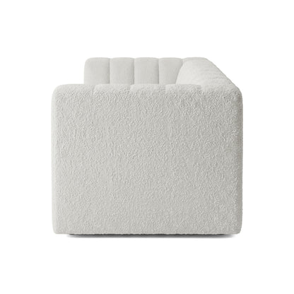 Side profile of a modern white sofa on a white background