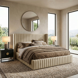 Beige king bed neatly made in a bright, styled bedroom