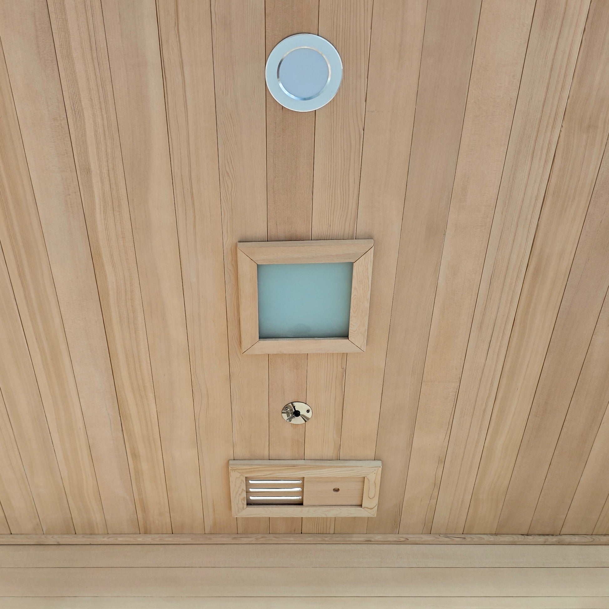 Wood-paneled ceiling with installed fixtures