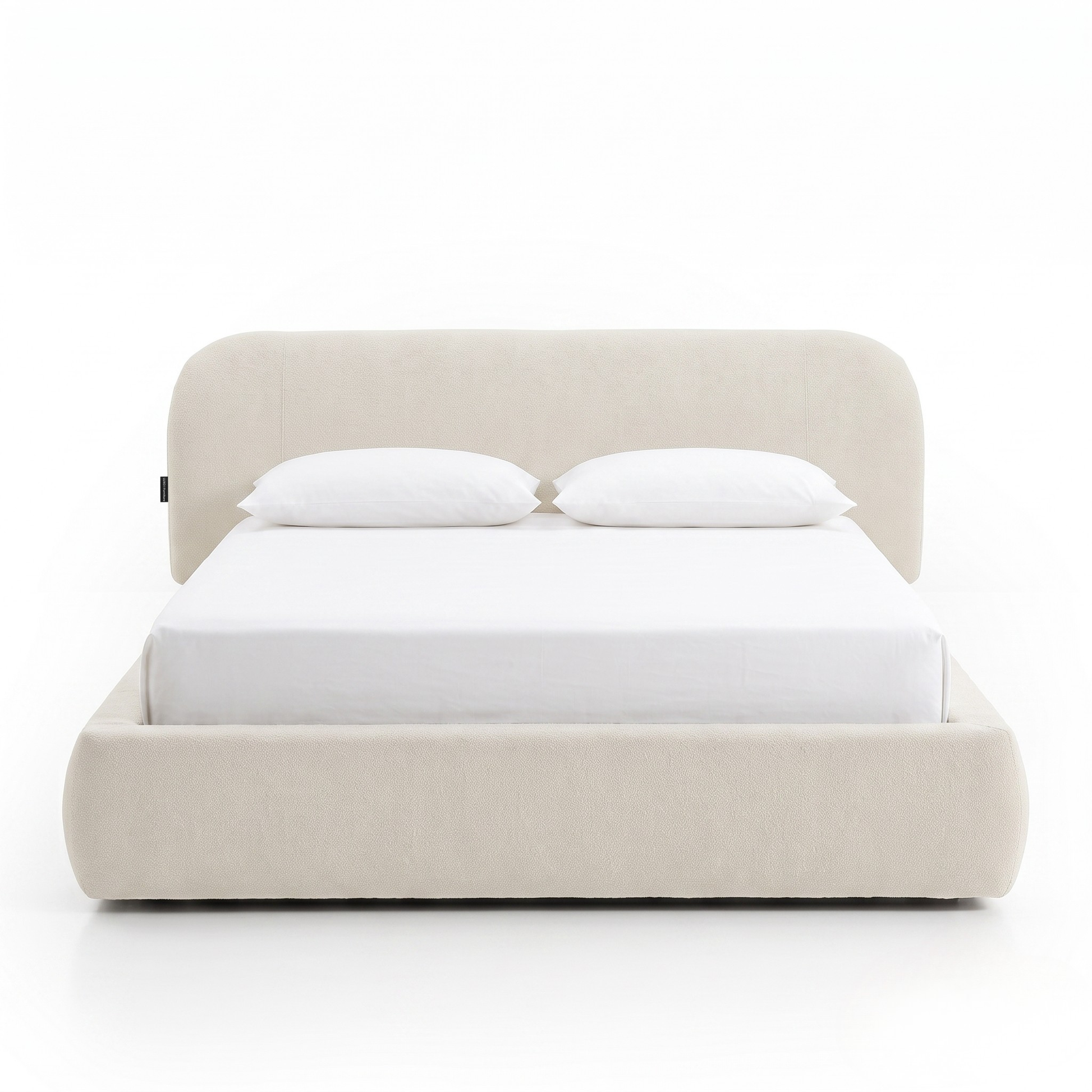 Modern upholstered bed with pillows shown fully on a white background