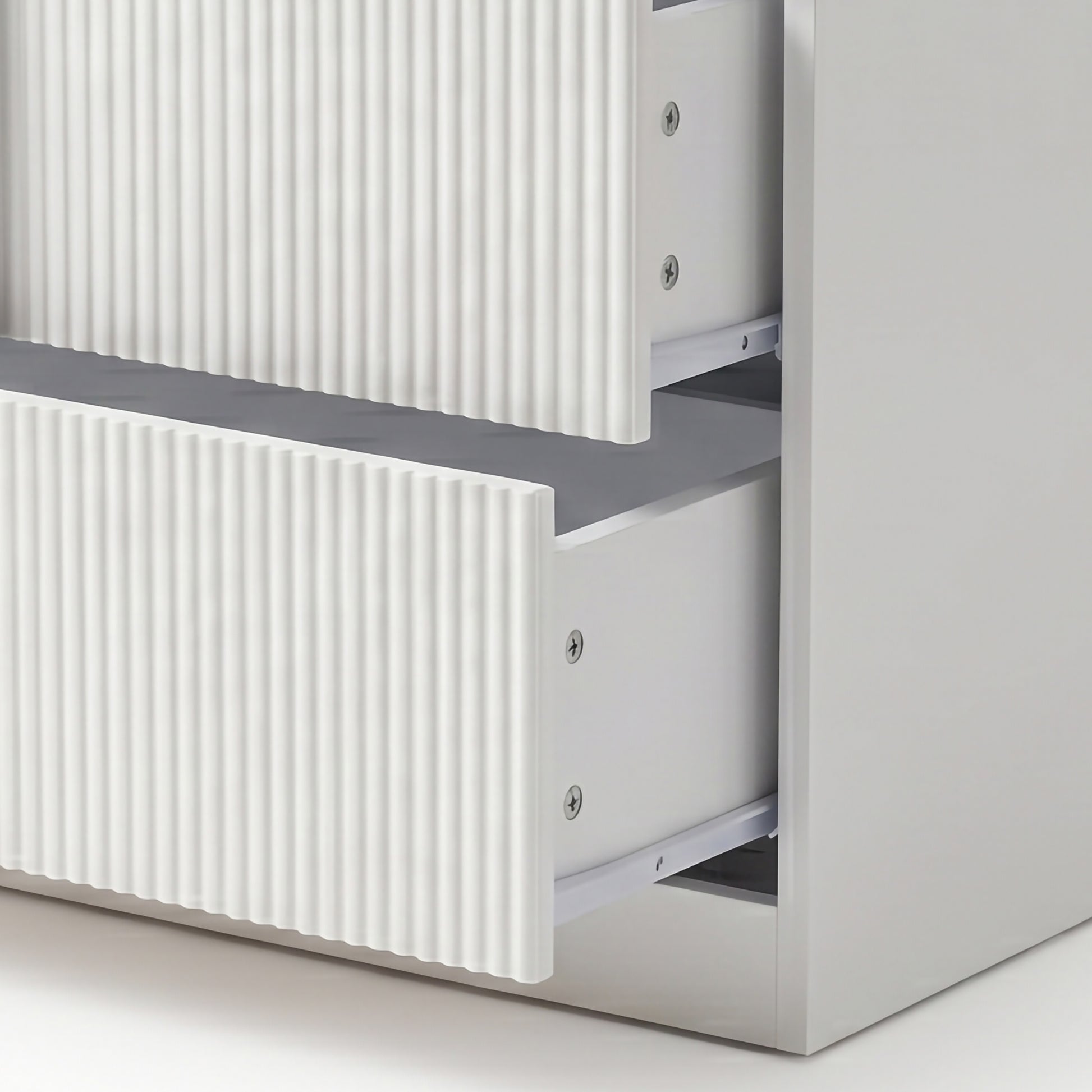 Close-up of two partially open drawers with ribbed fronts
