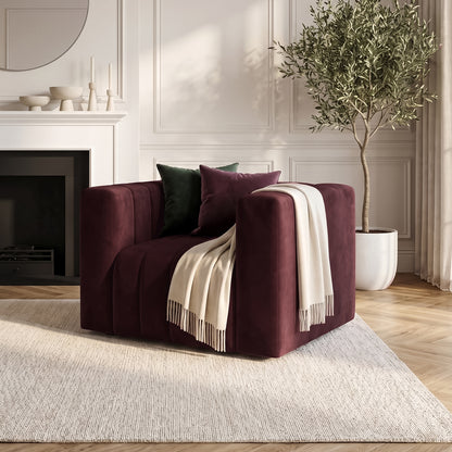 Dark Merlot armchair styled in a living room with pillows and throw blanket