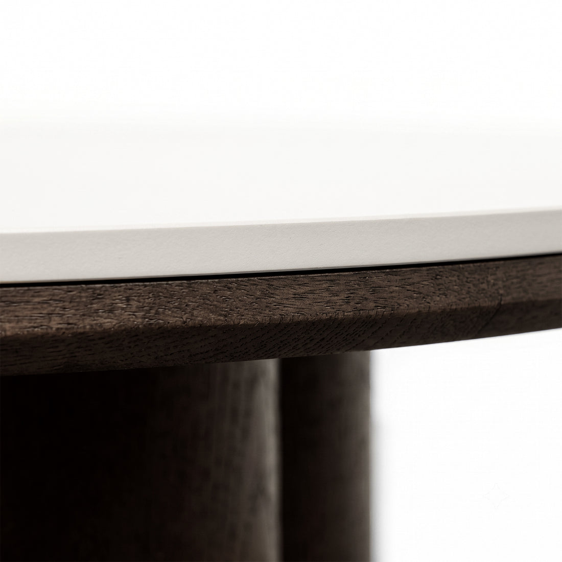 Close-up of the edge of a tabletop showing light surface and dark wood detail