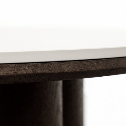 Close-up of the edge of a tabletop showing light surface and dark wood detail