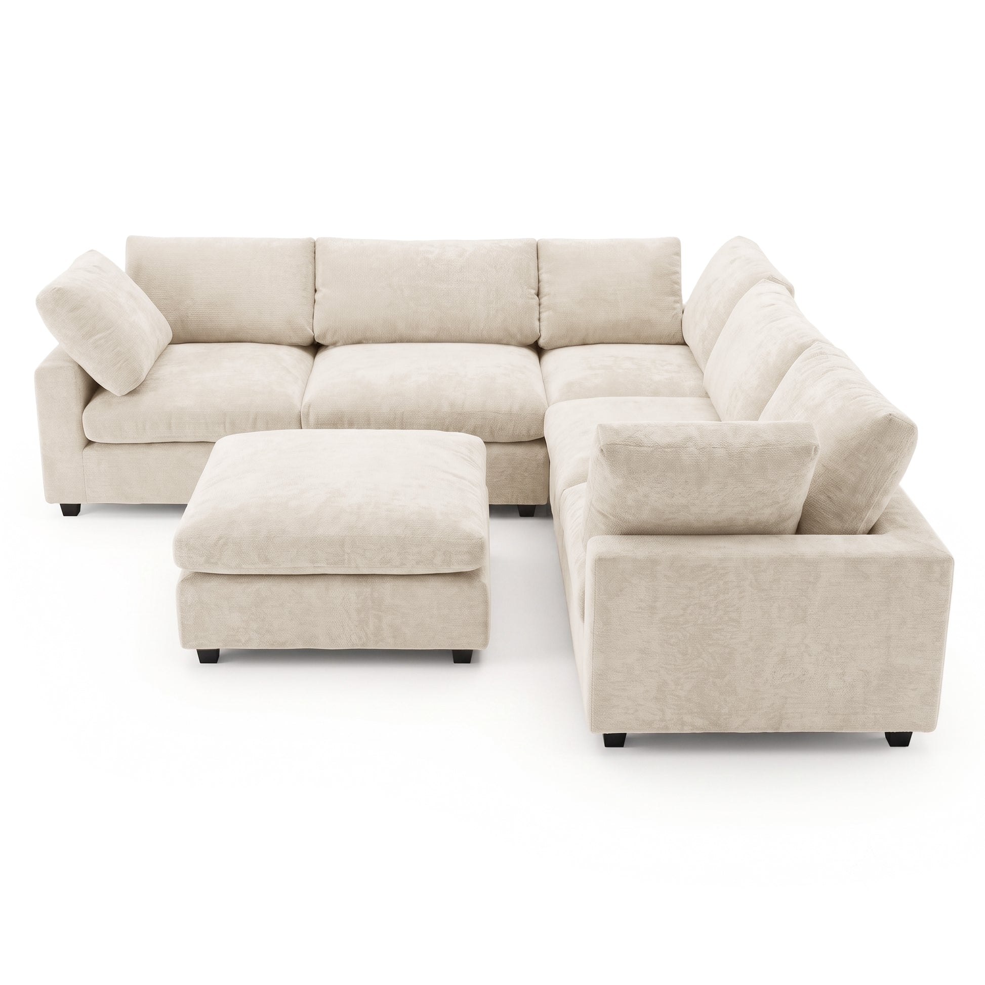 Beige sectional sofa with matching ottoman on white background