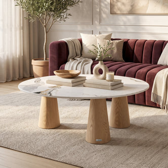 Oval marble-top coffee table styled in a modern living room