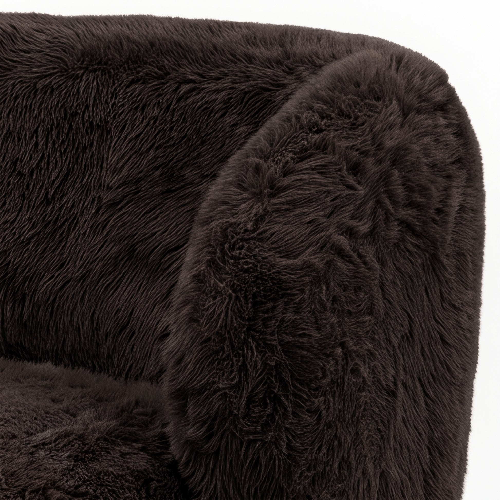 Close-up of a chocolate brown faux fur upholstered accent chair section on a white background
