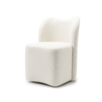 Sculptural white bouclé accent chair on a plain white background
