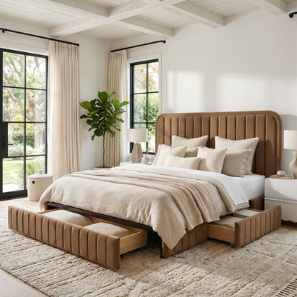 Upholstered bed in a bright bedroom with open under-bed storage drawers, pillows, rug, nightstands, and plant