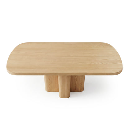 Rectangular wooden coffee table with rounded edges and four cylindrical legs on white background