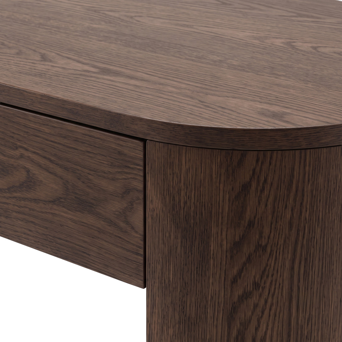 Close-up of a dark wood desk corner showing wood grain and joinery