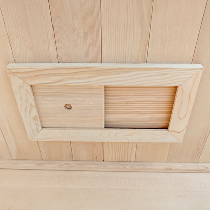 Wooden sliding panel installed in a wood-paneled wall