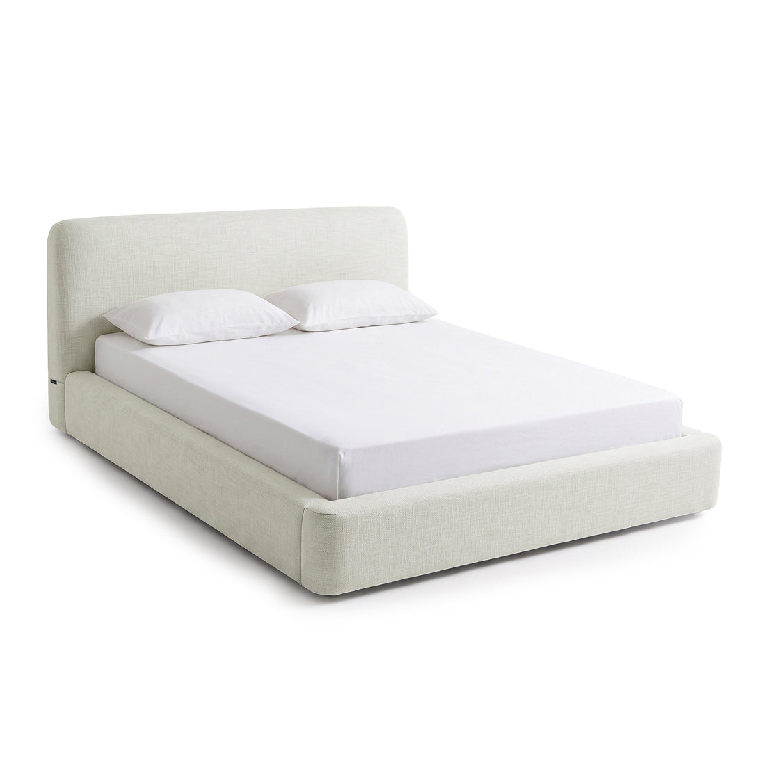 Modern upholstered bed with pillows on a white background