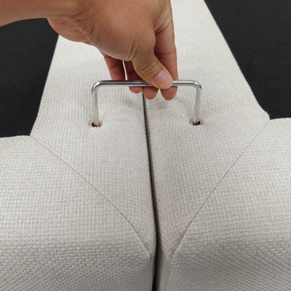 Close-up of a metal handle connecting upholstered furniture sections