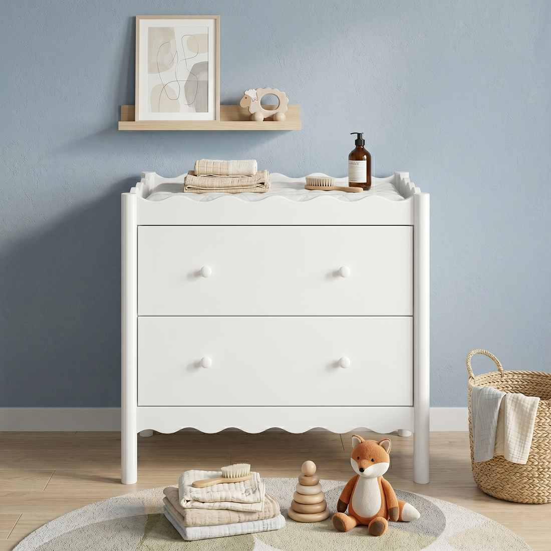 White nursery dresser styled in a cozy nursery room