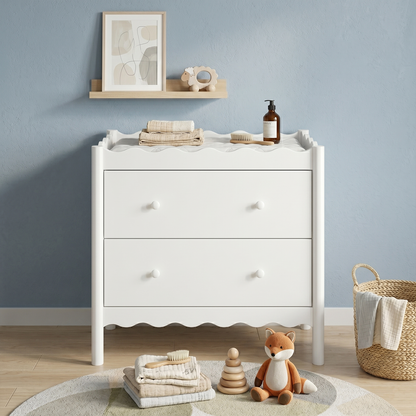 White nursery dresser styled in a cozy nursery room