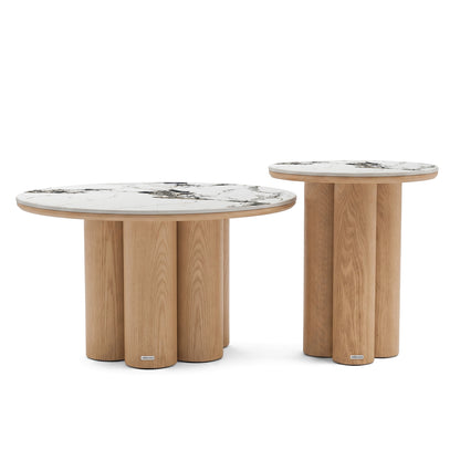 Two modern round nesting tables with marble-look tops and cylindrical wooden bases on a white background