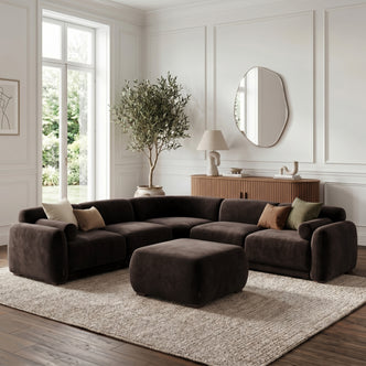 Modular sectional sofa with ottoman in a bright living room setting