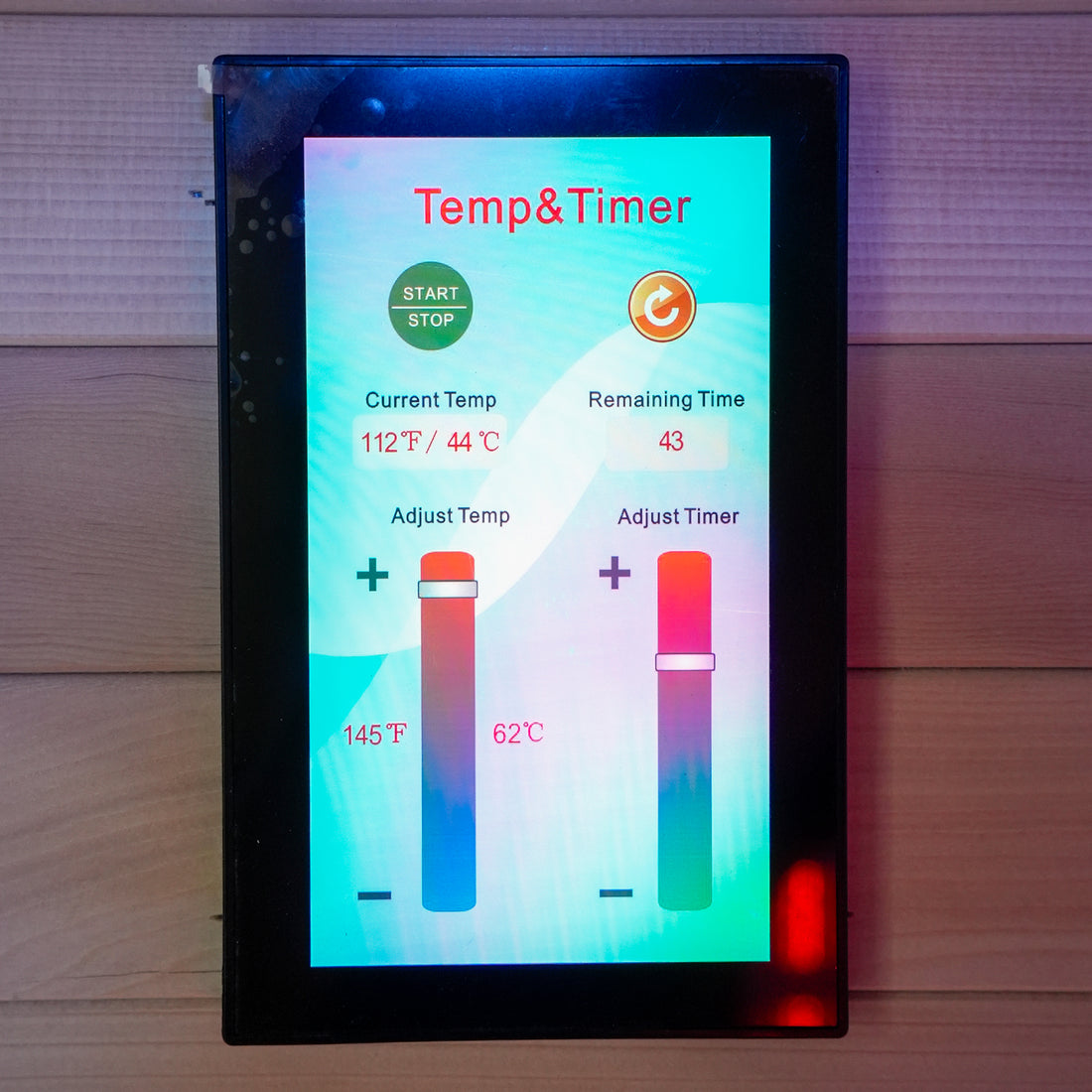 Digital sauna control panel mounted on a wood-paneled wall