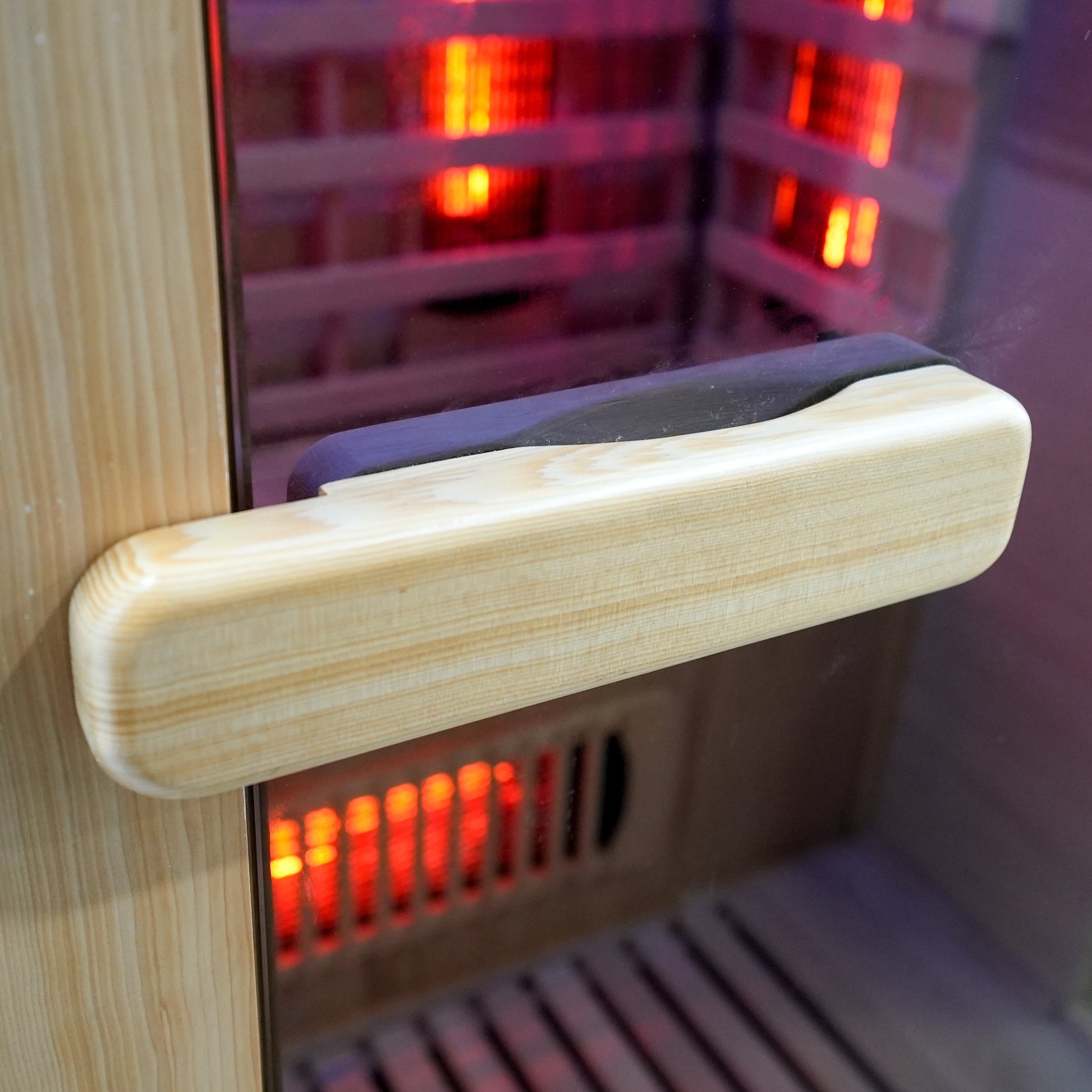 Wooden sauna door handle with interior heating elements visible