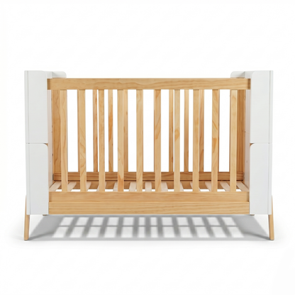 Modern wooden crib with white panels on white background