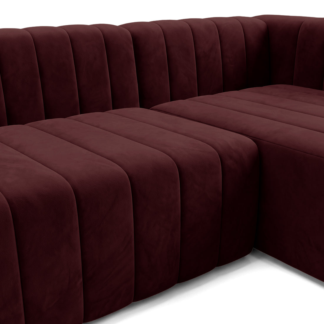 Partial view of a burgundy sectional sofa on a white background.