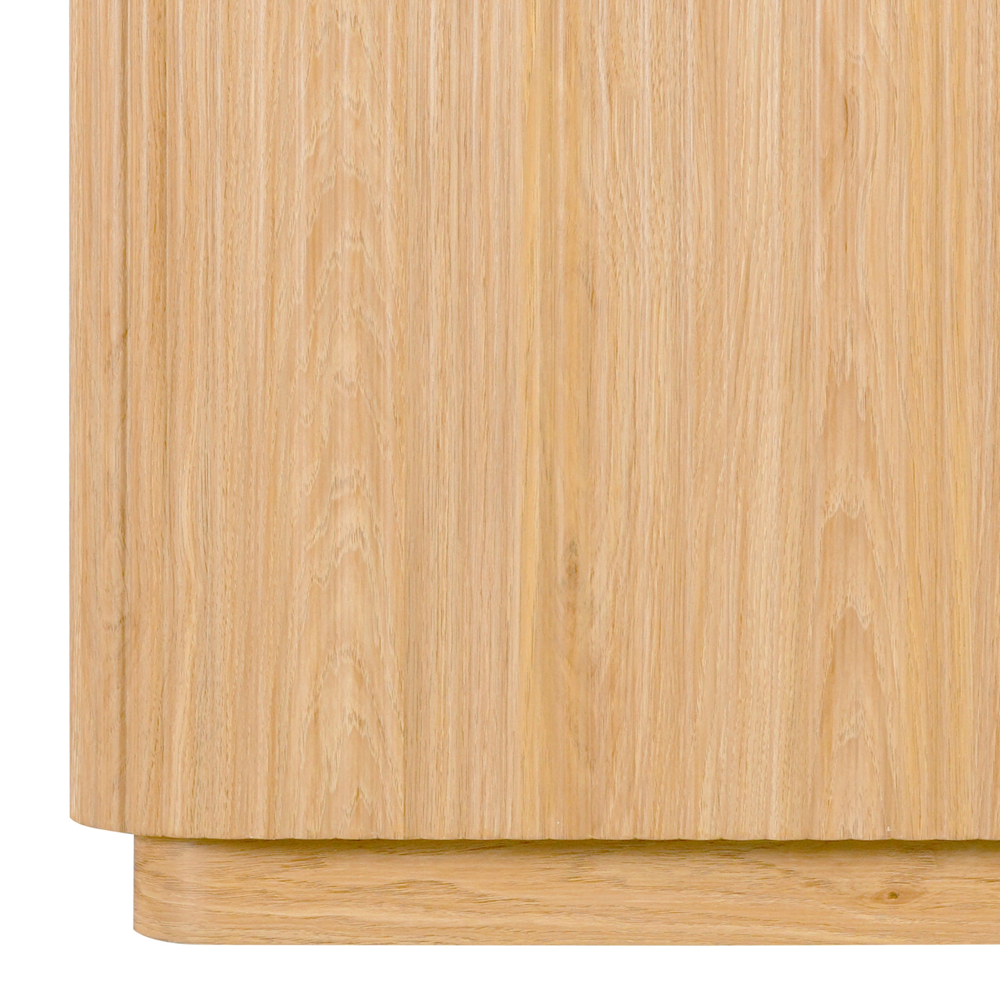Close-up of the lower side and base of a wooden sideboard on white background