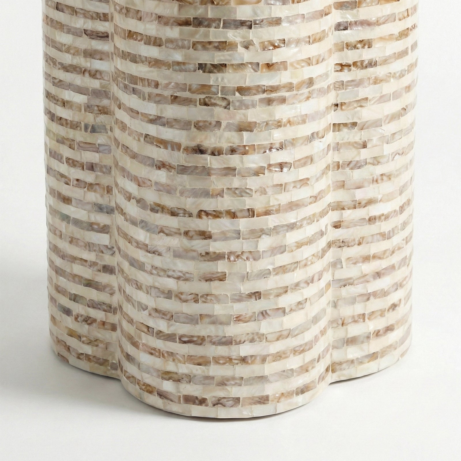 Partial view of cylindrical mosaic table base on white background