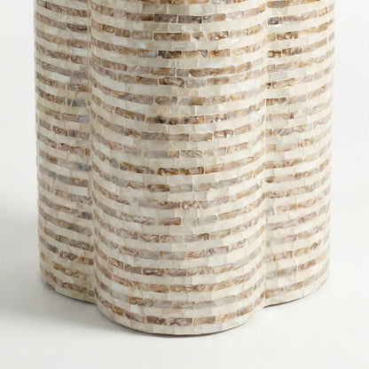Partial view of cylindrical mosaic table base on white background