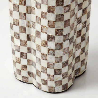 Detail of the lower section of a checkerboard-patterned table base on white background