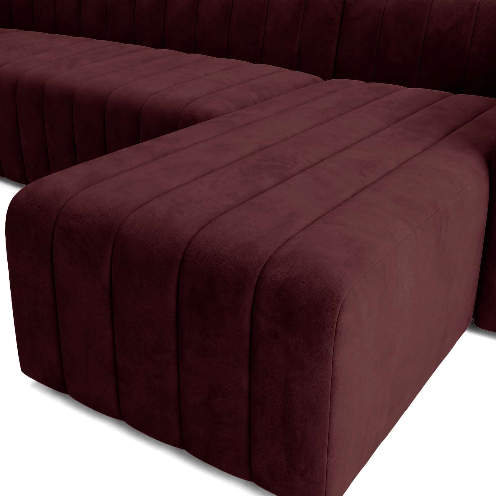 Close-up of burgundy upholstered sectional sofa corner detail.