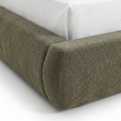 Close-up of upholstered bed frame corner on white background