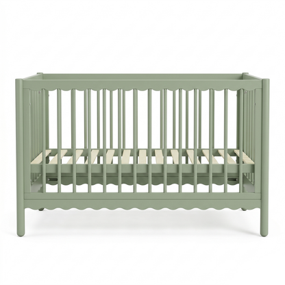 Front view of sage green baby crib on white background