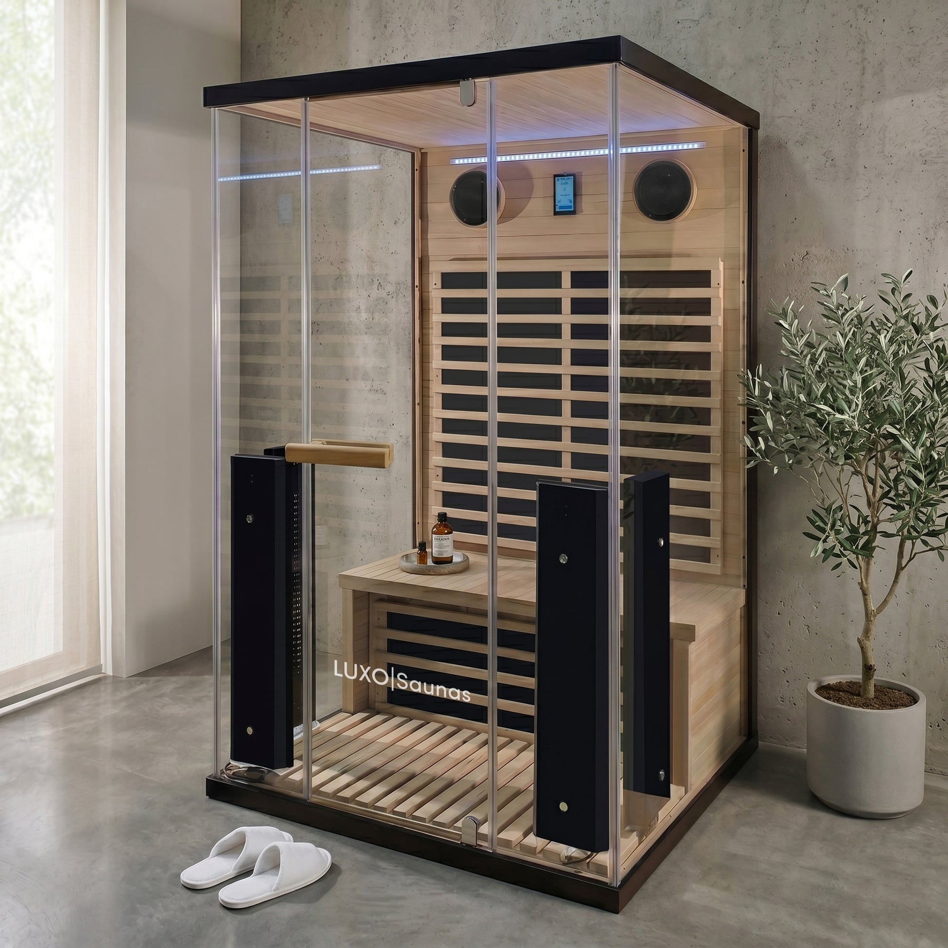 Full sauna unit installed in a modern room with plants and accessories