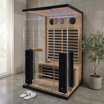 Full sauna unit installed in a modern room with plants and accessories