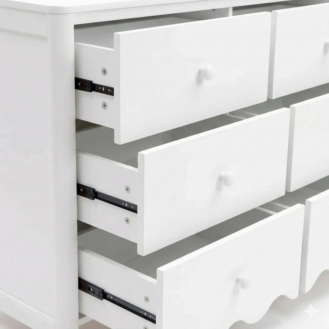 Close-up of white dresser drawers partially open on white background