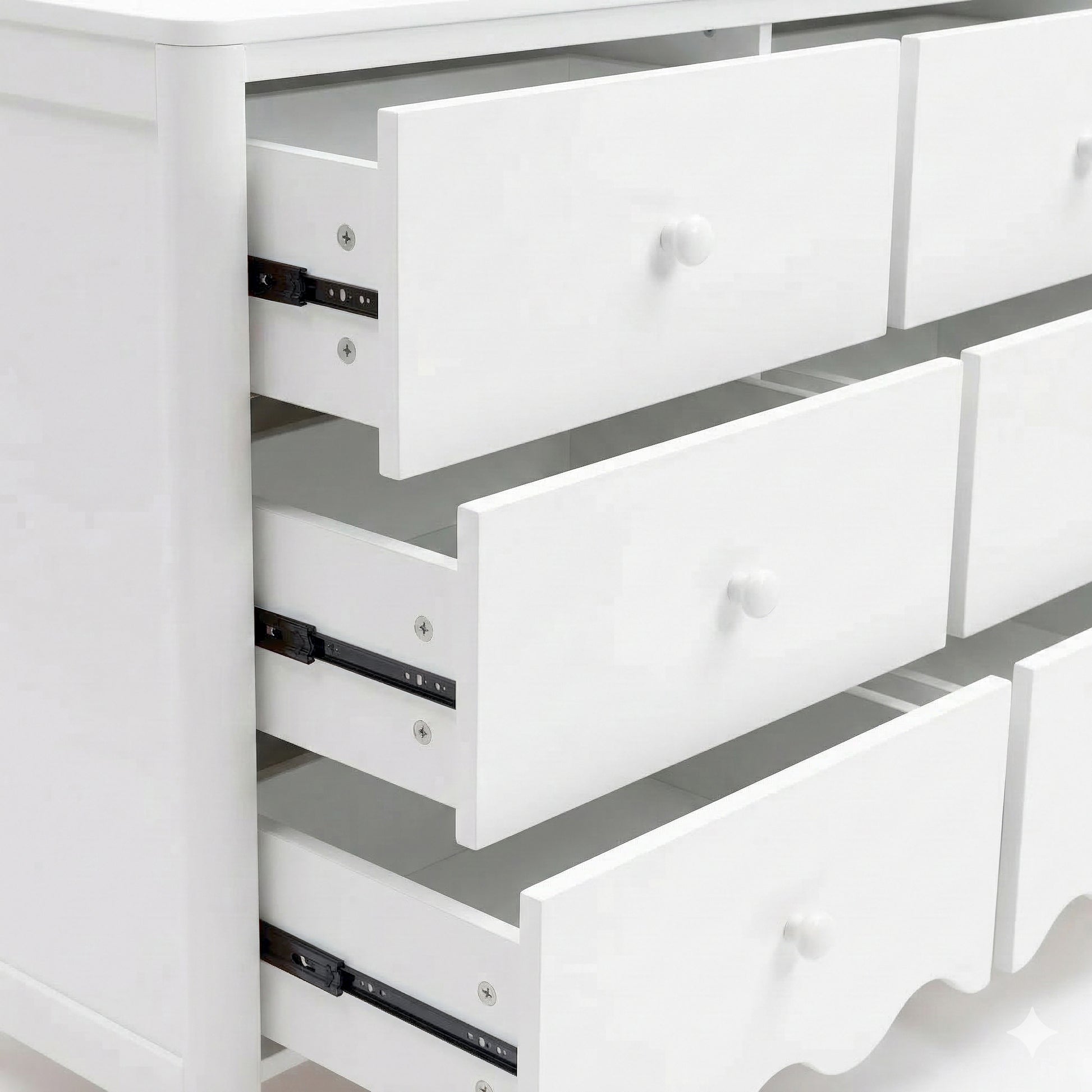 Close-up of white dresser drawers partially open on white background