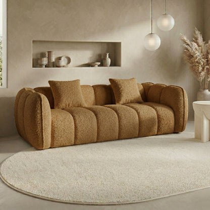 Brown sofa in a neutral-toned living room with rug and decor